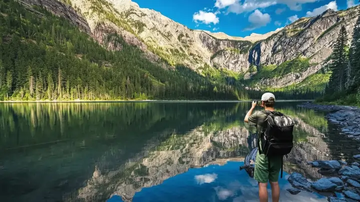 Photographer at shoreline Avalanche Lake