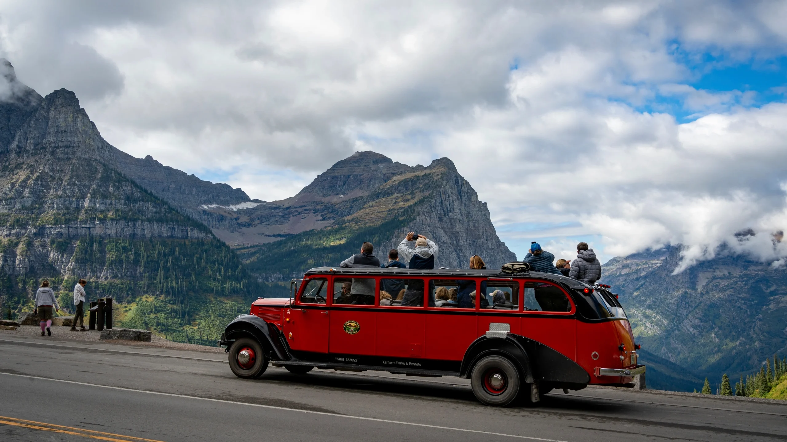 Historic Red Jammer open-top touring bus on Going-to-the-Sun Road in Glacier National Park