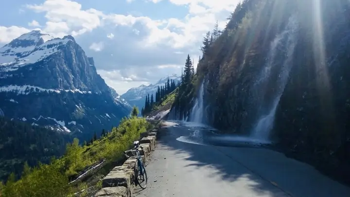 Going-to-the-Sun Road in autumn with golden larch trees and dramatic mountain scenery in Glacier National Park