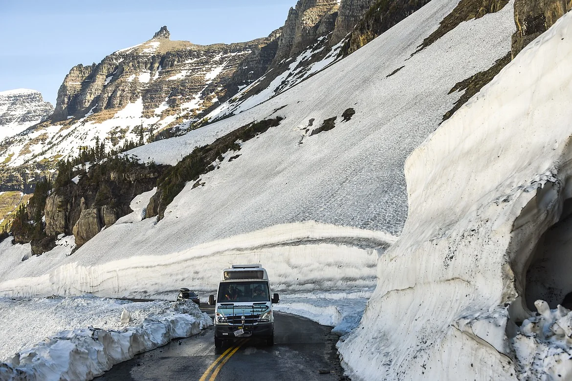 Winter bus on the snow-cleared Going-to-the-Sun Road near Lake McDonald in Glacier National Park